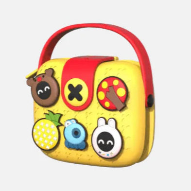 Yellow toy with red handle and various animal face designs on a white background